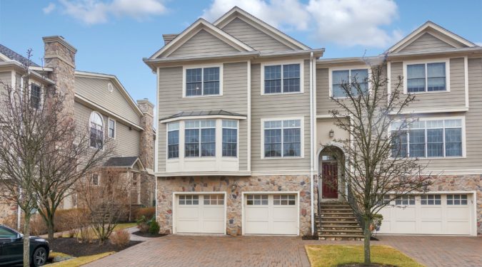 A large brick house with two garage doors.